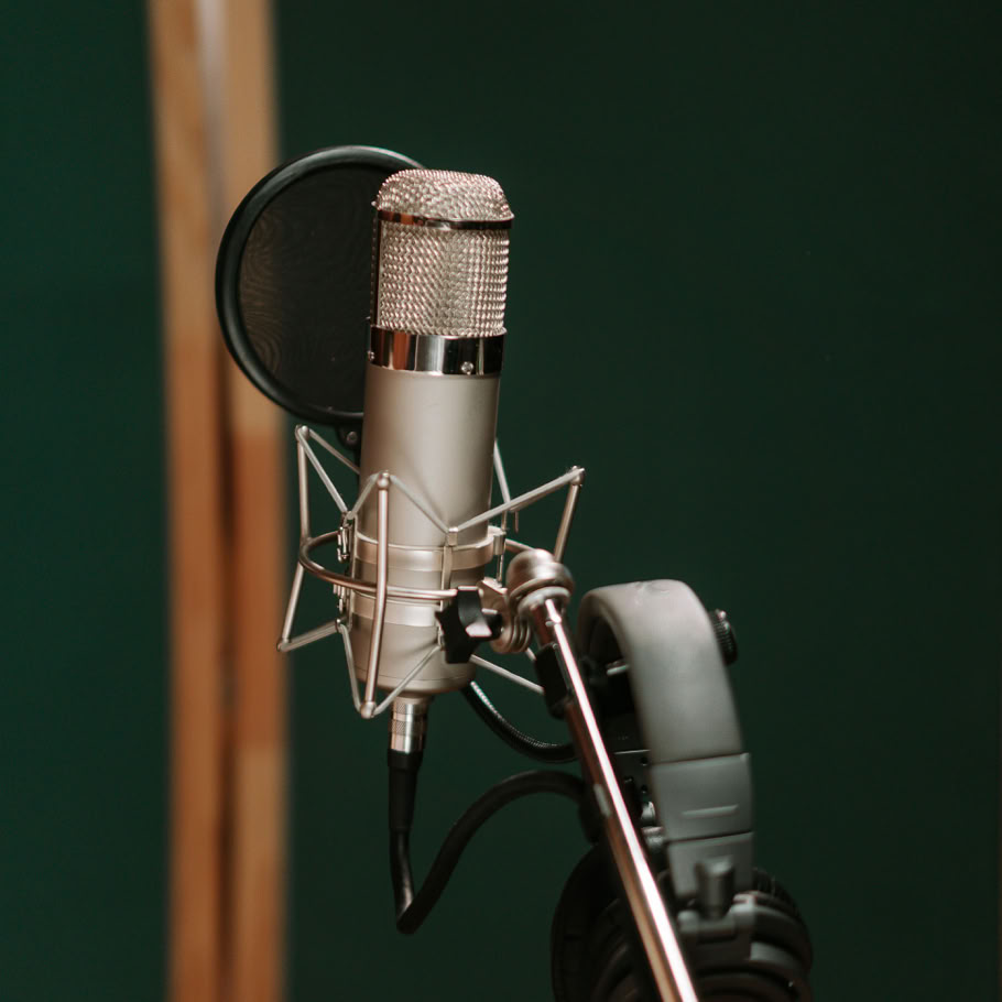 Close-up of a studio microphone with headphones, ideal for recording and broadcasting.